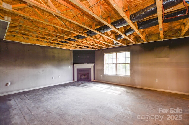 below grade area with baseboards and a fireplace