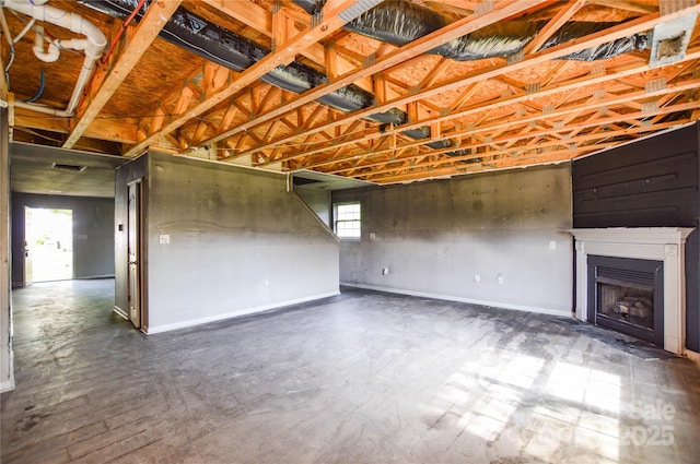 below grade area featuring a fireplace, a wealth of natural light, visible vents, and baseboards