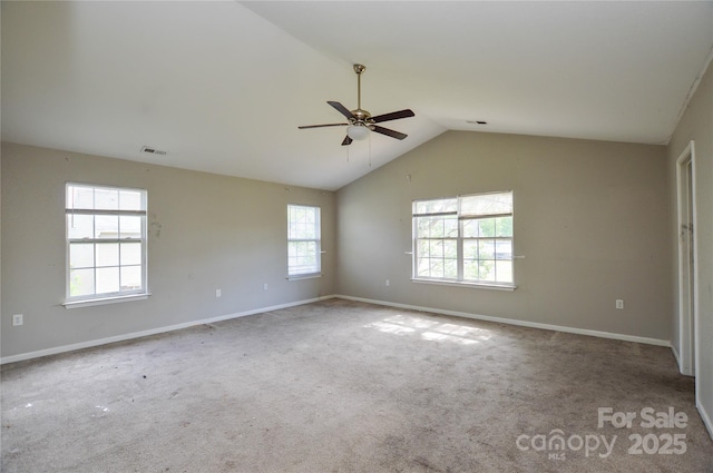 spare room featuring ceiling fan, baseboards, vaulted ceiling, and visible vents