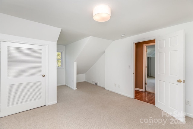bonus room featuring carpet floors and baseboards