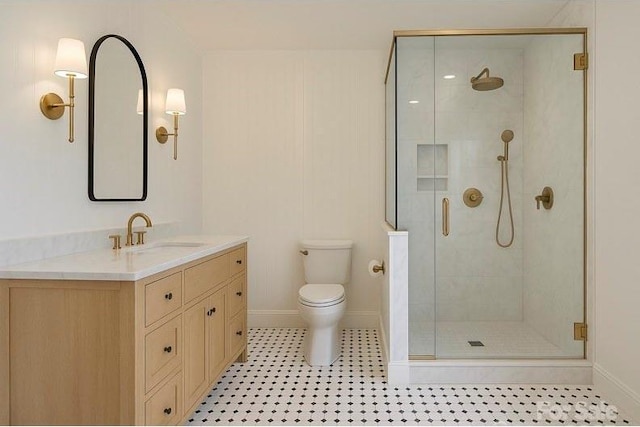 bathroom featuring baseboards, a stall shower, toilet, and vanity