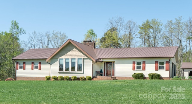 ranch-style home with a front yard, a chimney, and metal roof