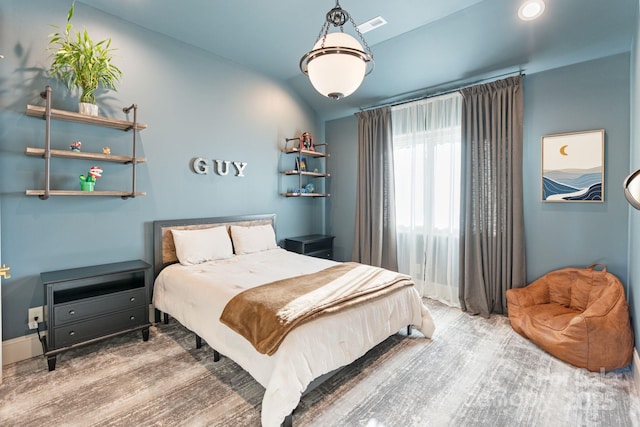 bedroom featuring vaulted ceiling and wood finished floors