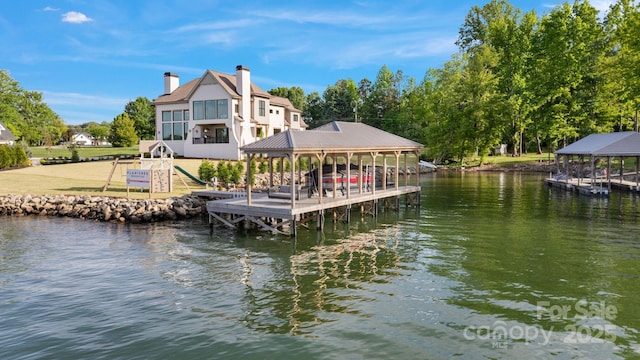 dock area with a water view and boat lift