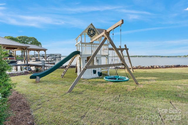 community playground with a yard and a water view