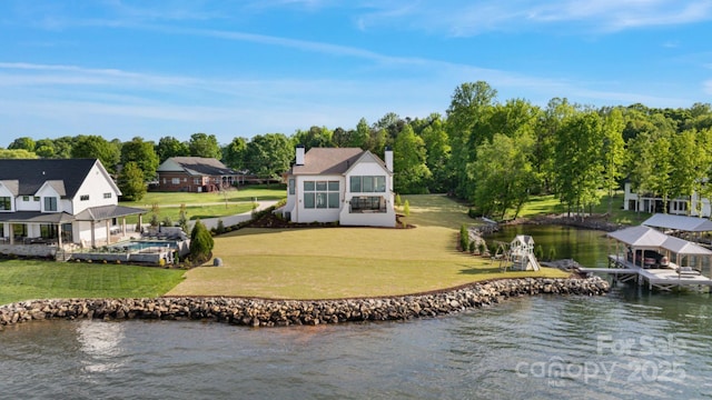 7679 Rabbit Cir, Denver, NC 28037 - rear view of property featuring a water view, boat lift, a chimney, a lawn, and an outdoor pool