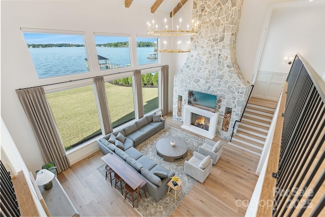 7679 Rabbit Cir, Denver, NC 28037 - living room with high vaulted ceiling, a chandelier, wood finished floors, a water view, and a fireplace