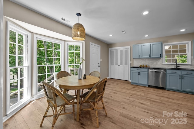 dining space with healthy amount of natural light, light wood-type flooring, and recessed lighting