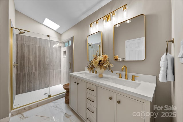 full bathroom featuring a skylight, marble finish floors, a stall shower, vaulted ceiling, and double vanity