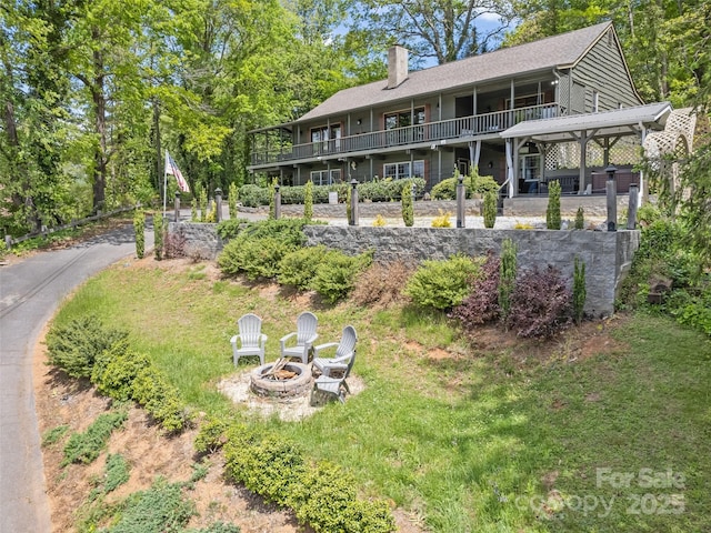 62 Cosmic Ln, Waynesville, NC 28786 - back of house featuring an outdoor fire pit and a chimney