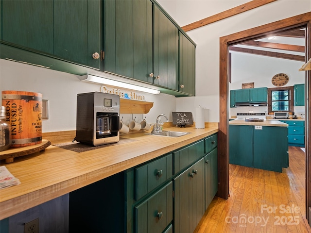 62 Cosmic Ln, Waynesville, NC 28786 - kitchen featuring a sink, beam ceiling, light countertops, light wood-style floors, and green cabinets