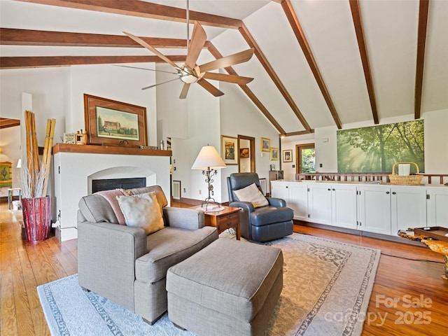 62 Cosmic Ln, Waynesville, NC 28786 - living room with ceiling fan, beam ceiling, light wood-style floors, a fireplace, and high vaulted ceiling
