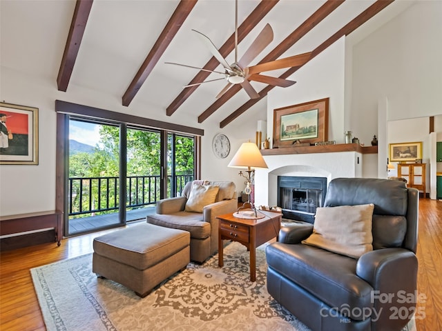 62 Cosmic Ln, Waynesville, NC 28786 - living area with beamed ceiling, a ceiling fan, a fireplace, wood finished floors, and high vaulted ceiling