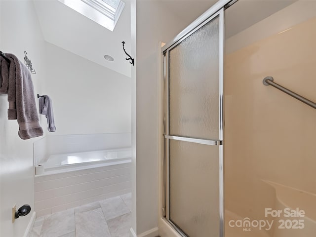 62 Cosmic Ln, Waynesville, NC 28786 - full bathroom featuring a stall shower, a garden tub, a skylight, and tile patterned floors