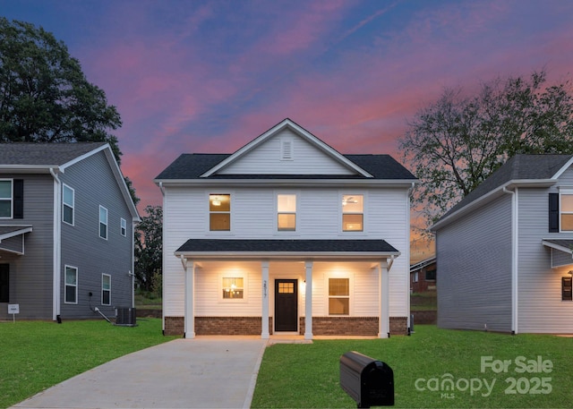 1841 Bear St, Charlotte, NC 28213 - view of front of property with brick siding, cooling unit, covered porch, concrete driveway, and a front lawn
