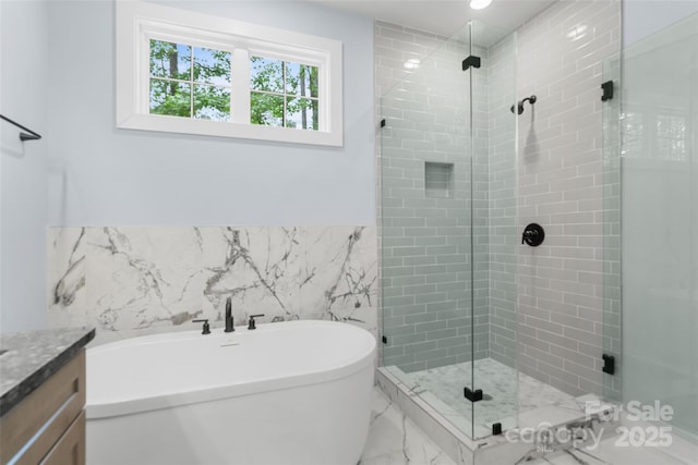 925 Twin Lakes Rd, Rock Hill, SC 29732 - full bathroom featuring marble finish flooring, a shower stall, a soaking tub, vanity, and tile walls