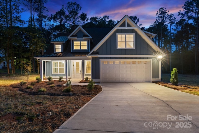 925 Twin Lakes Rd, Rock Hill, SC 29732 - view of front of home featuring board and batten siding, concrete driveway, a standing seam roof, metal roof, and a garage