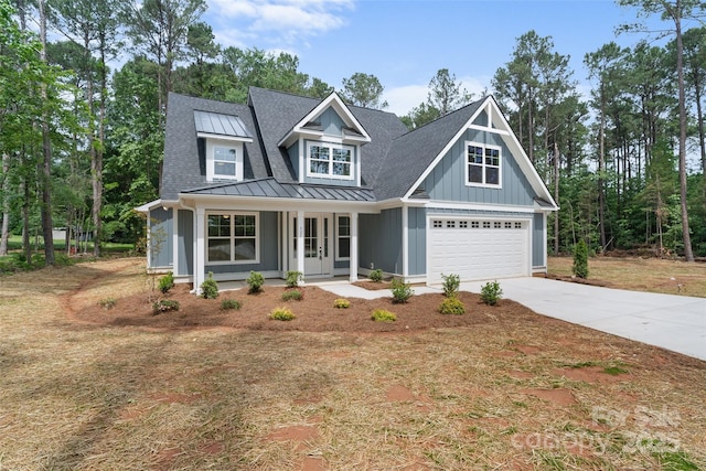 925 Twin Lakes Rd, Rock Hill, SC 29732 - view of front of house featuring a standing seam roof, driveway, covered porch, metal roof, and a shingled roof