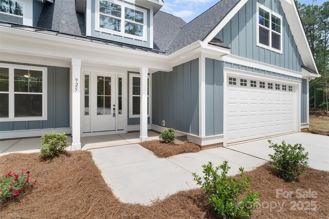 925 Twin Lakes Rd, Rock Hill, SC 29732 - doorway to property with board and batten siding, a shingled roof, a porch, and an attached garage