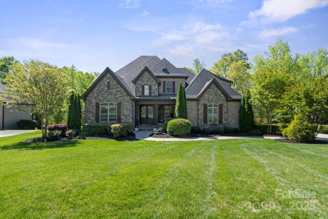 view of front of house featuring stone siding and a front yard