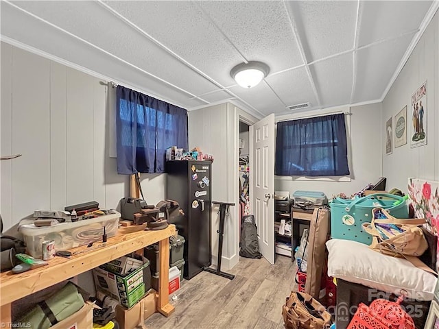 bedroom featuring visible vents, wood finished floors, and crown molding