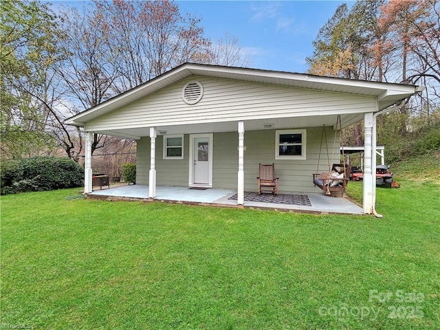 rear view of house with a lawn