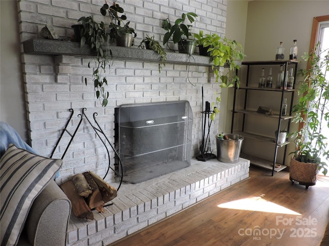 interior details featuring wood finished floors and a fireplace