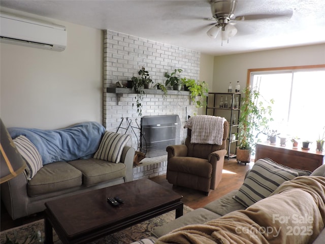 living room featuring a wall mounted air conditioner, a ceiling fan, and wood finished floors