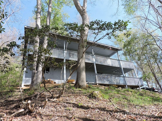 rear view of property featuring stucco siding