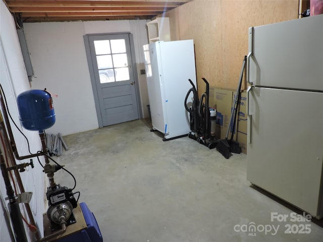 basement featuring freestanding refrigerator
