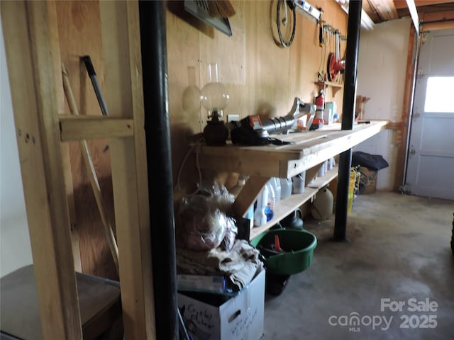 misc room with concrete floors and a workshop area