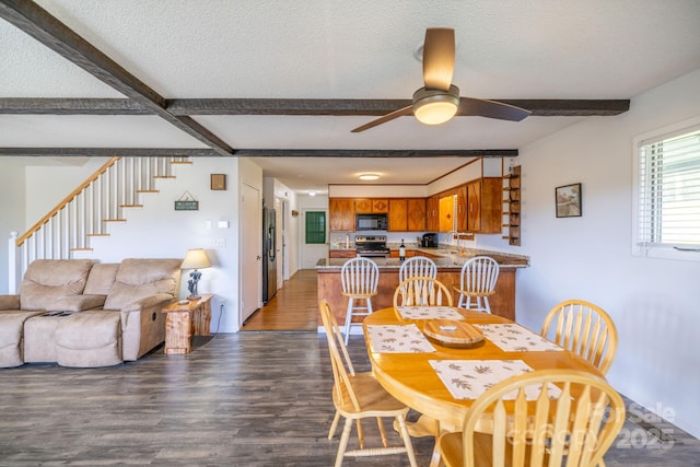 dining room with beamed ceiling, dark wood-type flooring, ceiling fan, and stairs
