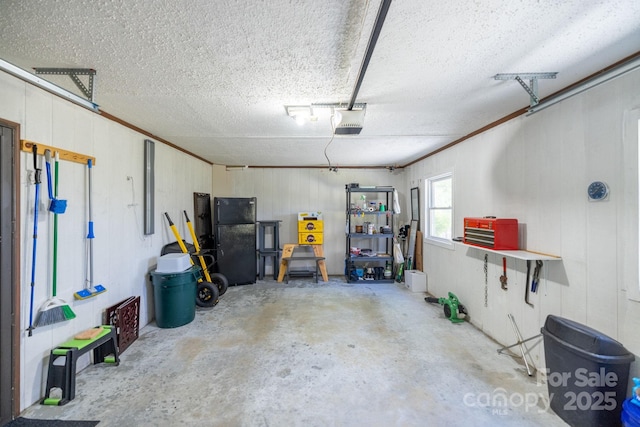 garage with freestanding refrigerator and a garage door opener