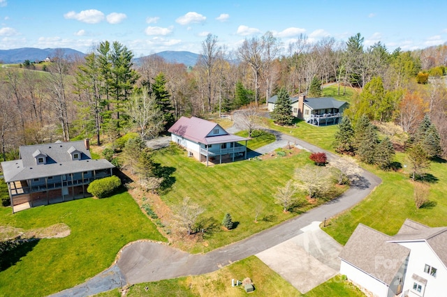 aerial view with a wooded view and a mountain view