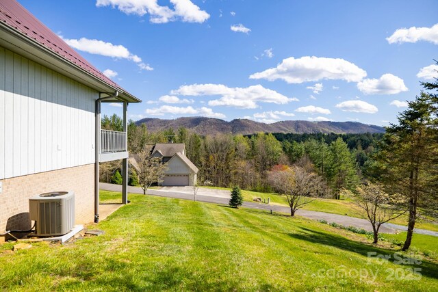 view of yard featuring central AC and a mountain view