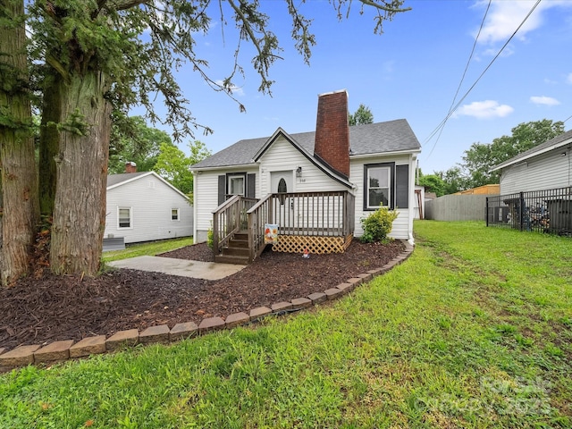 rear view of house with a chimney and a shingled roof