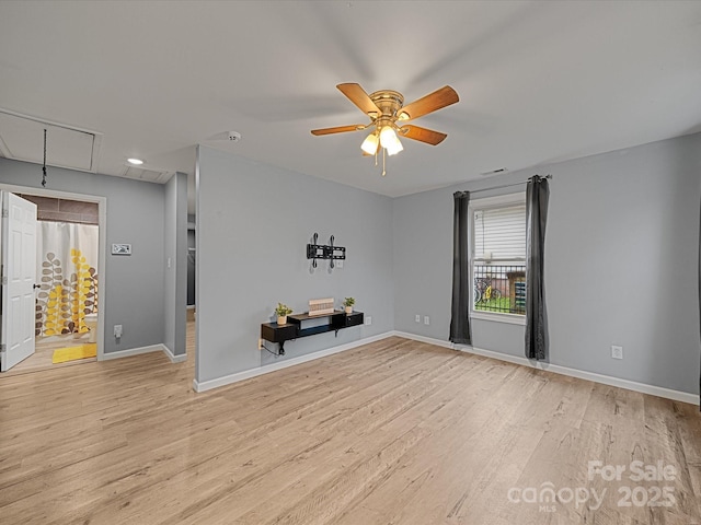 spare room with attic access, light wood-style flooring, ceiling fan, baseboards, and recessed lighting