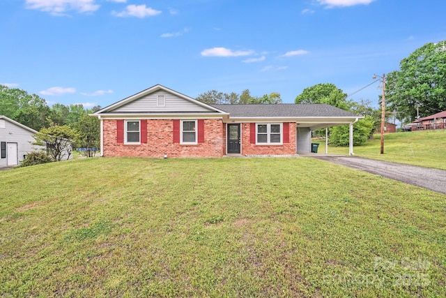 single story home featuring brick siding, aphalt driveway, an attached carport, and a front yard