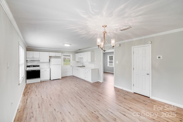 kitchen with under cabinet range hood, an inviting chandelier, light countertops, a sink, and white appliances