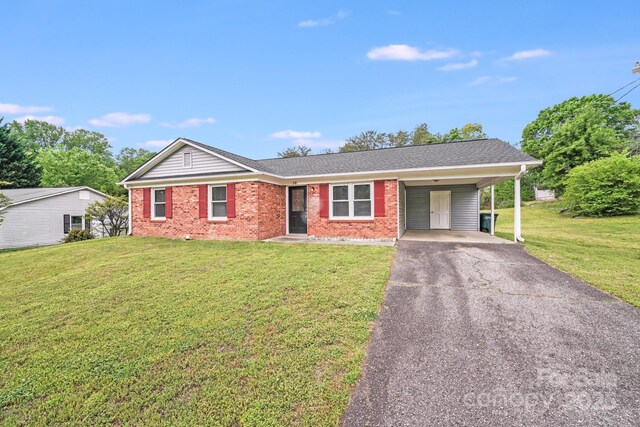 ranch-style house with brick siding, a front lawn, aphalt driveway, and an attached carport