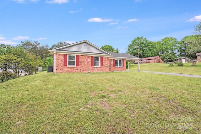 ranch-style house with brick siding, a front yard, and central air condition unit