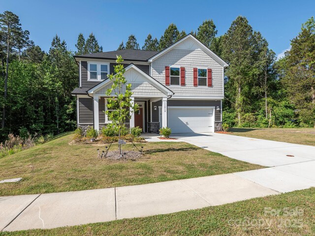 11010 Redcoat Hill Ln, Huntersville, NC 28078 - craftsman-style house featuring stone siding, a garage, concrete driveway, and a front yard