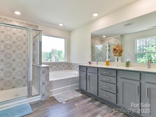 11010 Redcoat Hill Ln, Huntersville, NC 28078 - bathroom featuring a shower stall, double vanity, a bath, wood finished floors, and recessed lighting