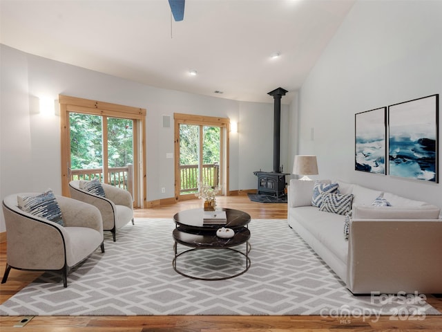 15 Sassy Ln, Asheville, NC 28805 - living area with light wood-style flooring, a wood stove, baseboards, and lofted ceiling