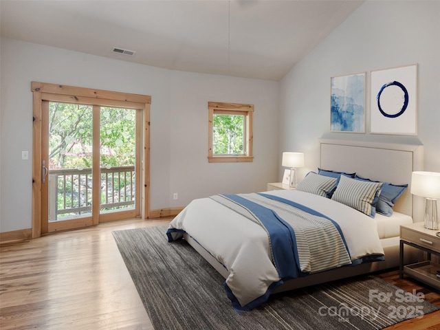 15 Sassy Ln, Asheville, NC 28805 - bedroom featuring access to exterior, wood finished floors, vaulted ceiling, and baseboards