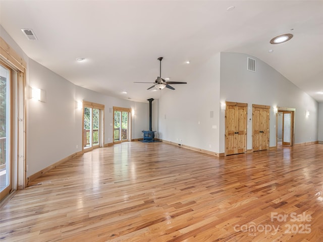 15 Sassy Ln, Asheville, NC 28805 - unfurnished living room with a wood stove, light wood-style flooring, a ceiling fan, baseboards, and recessed lighting