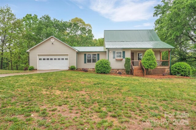 450 Lemmons Rd Unit 4, Mooresboro, NC 28114 - view of front of home with covered porch, a garage, metal roof, concrete driveway, and a front lawn