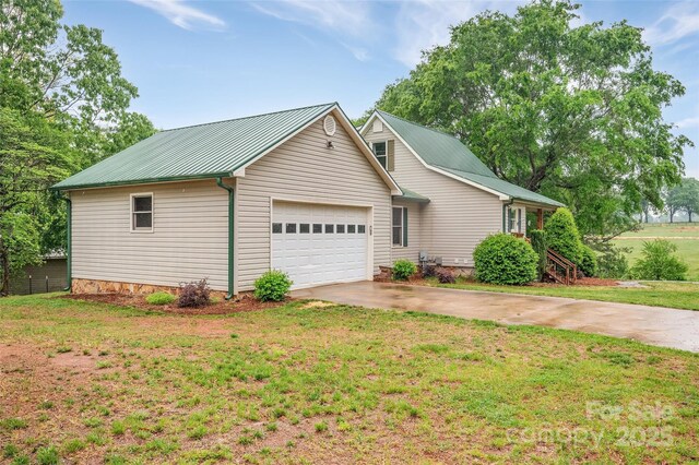 450 Lemmons Rd Unit 4, Mooresboro, NC 28114 - view of property exterior with a garage, metal roof, a lawn, and concrete driveway