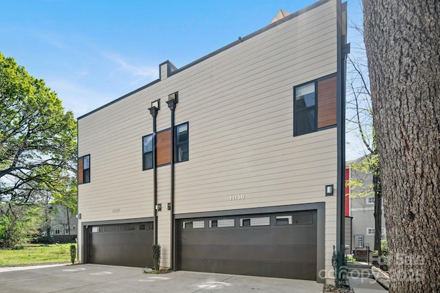 1115 Greenleaf Ave Unit B, Charlotte, NC 28202 - view of side of property with an attached garage and concrete driveway