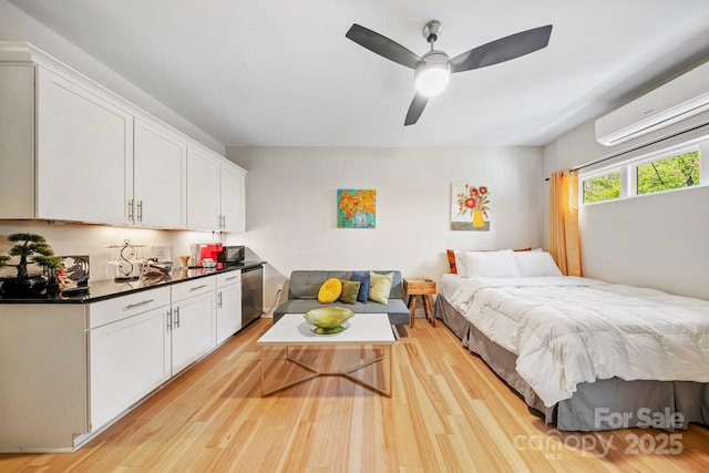 1115 Greenleaf Ave Unit B, Charlotte, NC 28202 - bedroom featuring a wall unit AC, a ceiling fan, and light wood-type flooring